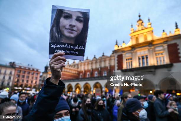 Protestor holds a portrait of Iza from Pszczyna during 'Not one more!' protest after 30-year-old woman died of septic shock in her 22nd week of...