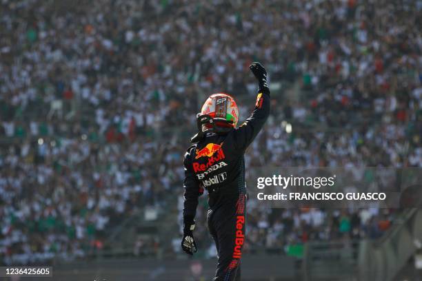 Red Bull's Mexican driver Sergio Perez celebrates after winning the third place of the Formula One Mexico Grand Prix at the Hermanos Rodriguez...