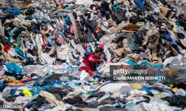 Woman searches for used clothes amid tons discarded in the Atacama desert, in Alto Hospicio, Iquique, Chile, on September 26, 2021. EcoFibra,...