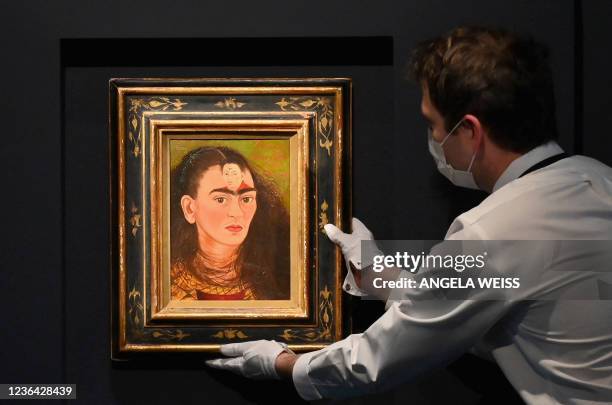 An art handler adjusts Frida Kahlo's final "Bust" Self-Portrait 'Diego y yo" at Sotheby's on November 5, 2021 in New York City. - After more than a...