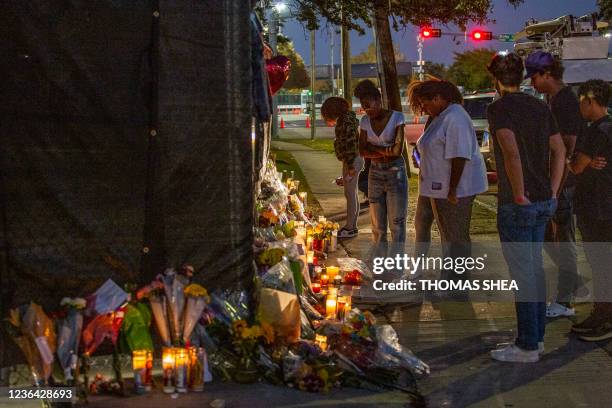 People attend a makeshift memorial on November 7, 2021 at the NRG Park grounds where eight people died in a crowd surge at the Astroworld Festival in...
