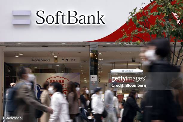 Pedestrians in front of a SoftBank Corp. Store in Tokyo, Japan, on Sunday, Nov. 7, 2021. SoftBank Group Corp. Might see a return to investment losses...