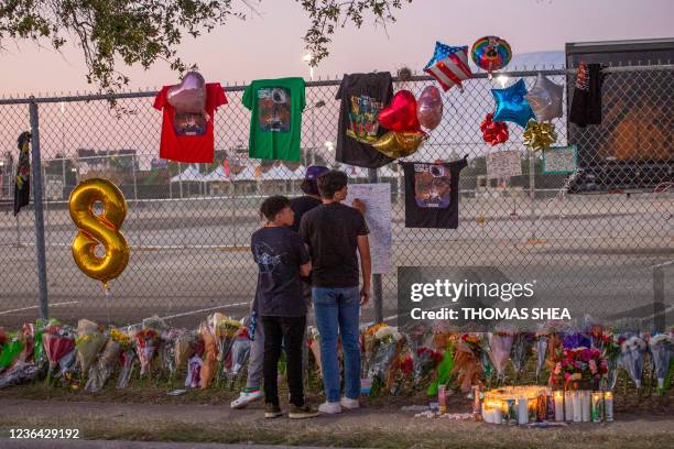 Seventeen years old local high School friends who attended the Travis Scott concert, Isaac Hernandez and Matthias Coronel watch Jesus Martinez sign a...