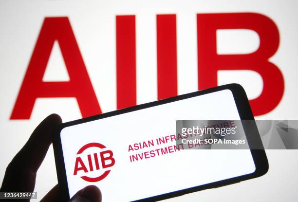 In this photo illustration, an Asian Infrastructure Investment Bank logo is seen on a smartphone.