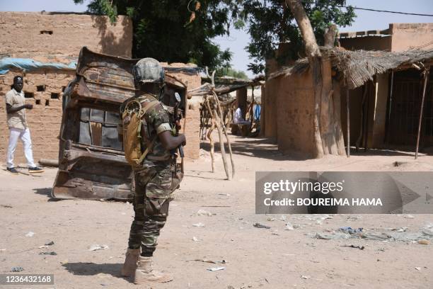 Nigerien soldier stands guard in a street near a market in Banibangou, a town in the west of Niger, on November 6 where 69 people died in a jihadist...