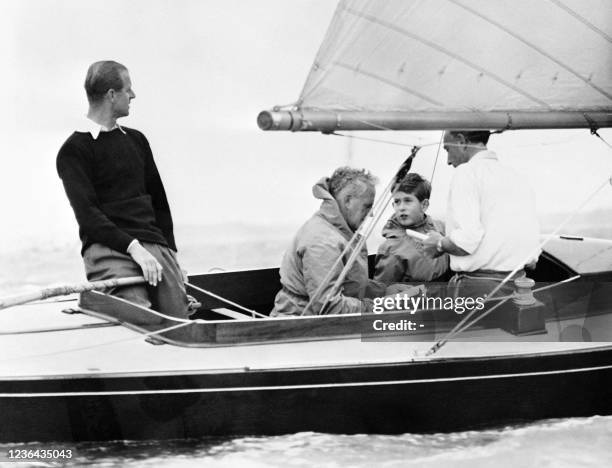 Prince Philip the Duke of Edinburgh enjoys a boat ride with his son Charles in Cowes in the 50s.