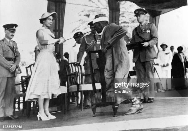 Yemen councillor Sayyid Abubakr bin Shaikh Alkaff kneels before Queen Elizabeth II to be knighted during the Sovereign visit to Aden, on April 29,...