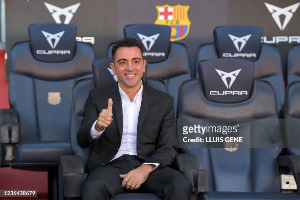 Newly-appointed FC Barcelona's Spanish coach Xavi Hernandez poses for pictures during his presentation ceremony at the Camp Nou stadium in Barcelona...