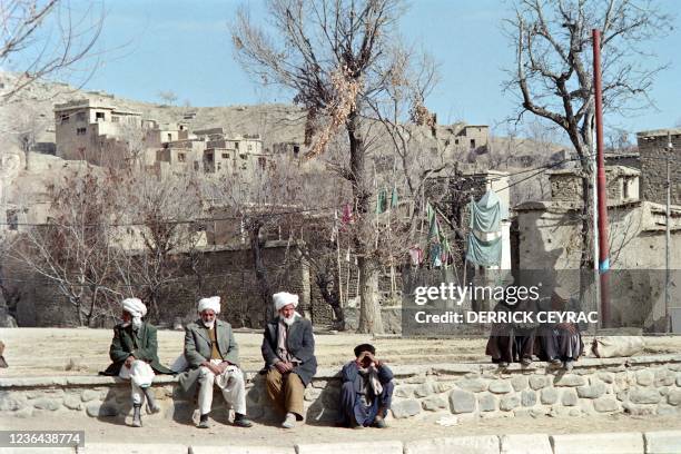 Old Afghan men sit on January 28, 1987 in Paghman, northwest Kabul, three months after the withdrawal of six Soviet regiments, and after the...