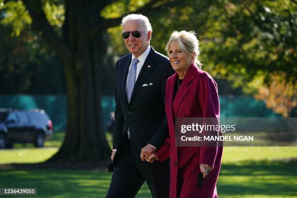 President Joe Biden and First Lady Jill Biden walk across the South Lawn upon return to the White House in Washington, DC on November 8, 2021. -...