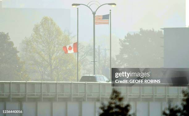 Travellers cross the Rainbow Bridge from Niagara Falls, Ontario, to Niagara Falls, New York through the fog on November 8, 2021. - The United States...