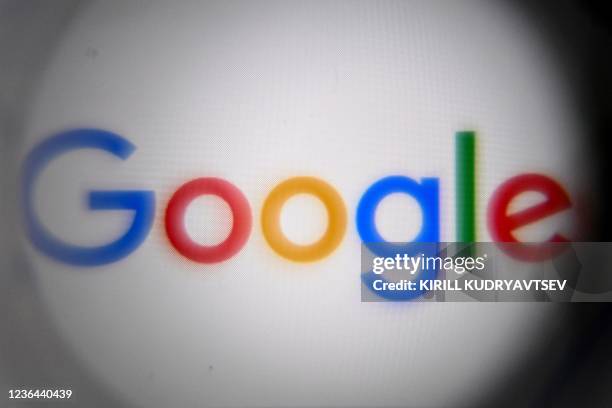 Picture taken on November 8, 2021 in Moscow shows the US multinational technology and Internet-related services company Google's logo on a smartphone...