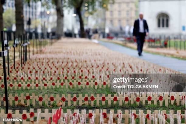 Rows of crosses with poppies are laid out to make a field of Remembrance beside Westminster Abbey in preparation for the main Remembrance Sunday...