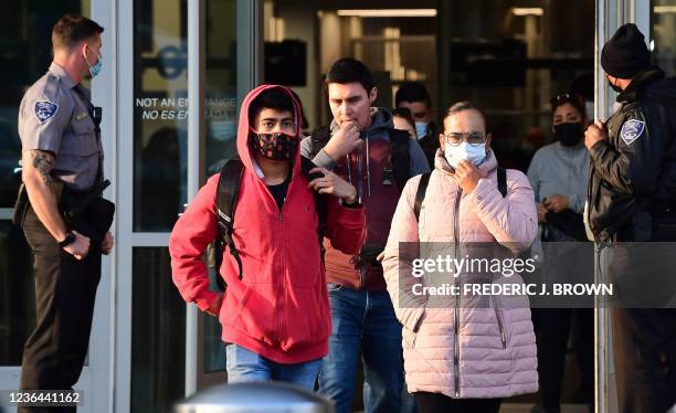 People wear facemasks upon entry from Mexico into the United States at the San Ysidro Land Port Entry in San Ysidro, California on November 8, 2021....