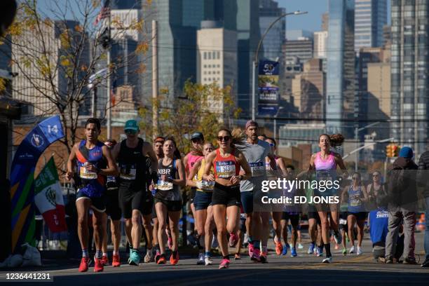 Runners compete during the 2021 TCS New York City Marathon in Brooklyn, New York on November 7, 2021. - After a forced break in 2020, the New York...