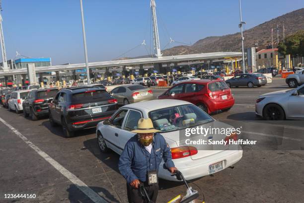 Motorists wait in line to cross the border at the San Ysidro Port of Entry on November 8, 2021 in Tijuana, Mexico. Monday was the official opening of...