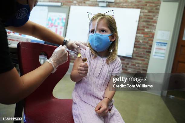 Year-old receives a Pfizer-BioNTech COVID-19 vaccine from pharmacist Joan Kim, owner of Grubbs Pharmacy, at the Capitol Hill Day School in...