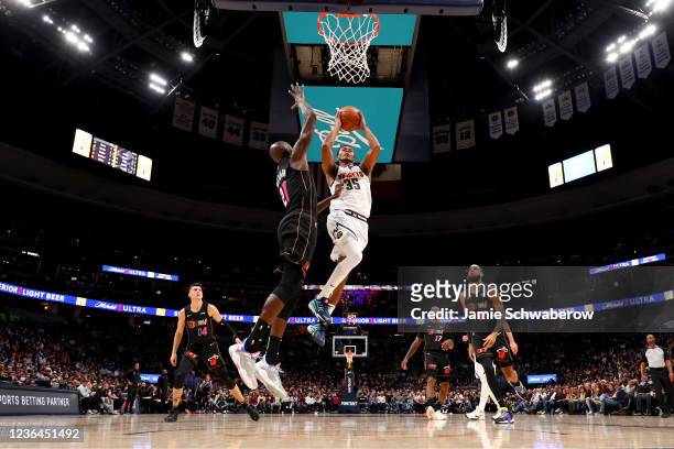Dozier of the Denver Nuggets drives against Dewayne Dedmon of the Miami Heat at Ball Arena on November 8, 2021 in Denver, Colorado. NOTE TO USER:...