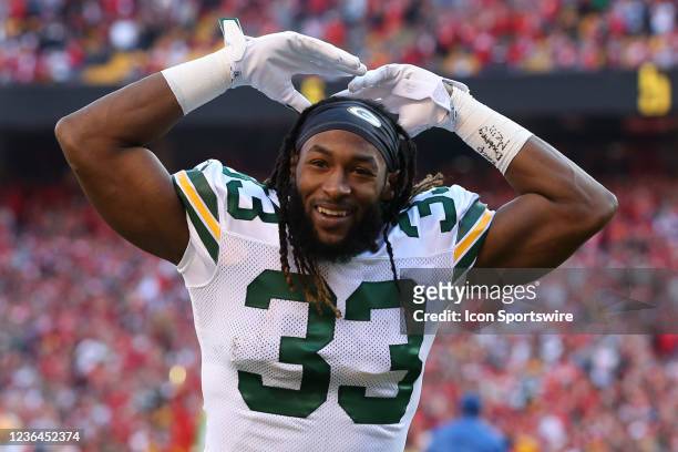 Green Bay Packers running back Aaron Jones raises his hands to fire up Packers fans before an NFL game between the Green Bay Packers and Kansas City...