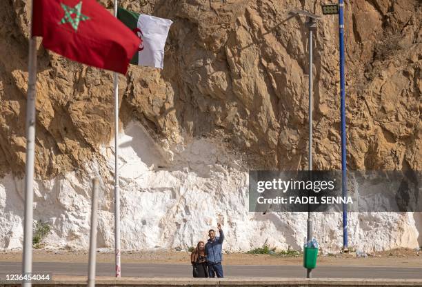 Picture taken from the Moroccan region of Oujda shows Algerians waving along the border with Morocco on November 4, 2021. - Algeria has accused its...