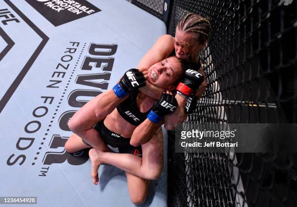 Katlyn Chookagian attempts to secure a rear choke submission against Antonina Shevchenko of Kyrgyzstan in their flyweight fight during the UFC Fight...