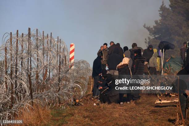 Picture taken on November 9, 2021 shows migrants at the Belarusian-Polish border in the Grodno region. - Poland and Belarus squared off on November 9...