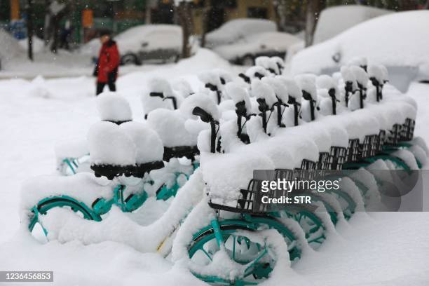 Bicycles covered with snow are seen in Shenyang in China's northeastern Liaoning province on November 9, 2021. - China OUT / China OUT