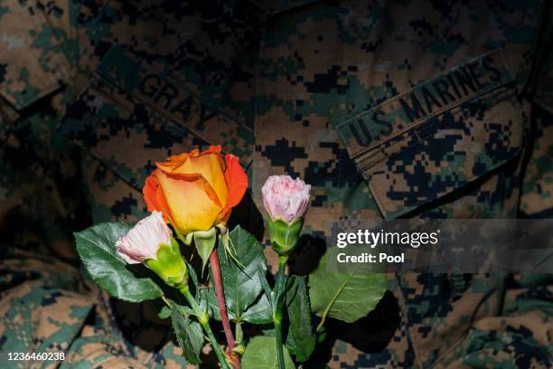 Marine holds flowers to be placed during a centennial commemoration event at the Tomb of the Unknown Soldier in Arlington National Cemetery on...