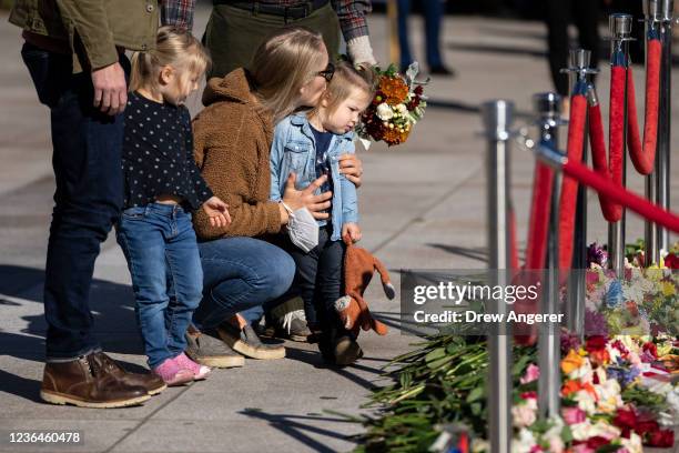 Family lays flowers during a centennial commemoration event at the Tomb of the Unknown Soldier at Arlington National Cemetery on November 9, 2021 in...