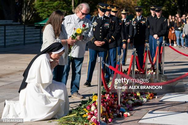 Nun prays after placing flowers during a centennial commemoration event at the Tomb of the Unknown Soldier, in Arlington National Cemetery in...