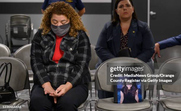 Santa Ana, CA Cynthia Curren tearfully sits next to a photo of her niece, Adriana Davies, who died at age 18 after taking half a pill of what she...