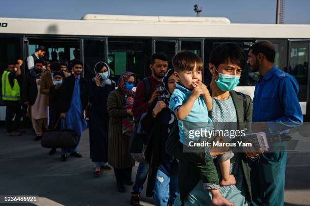 Zaki Daryabi, the founder of Etilaat Roz, the well known Afghan newspaper, his wife Humaira Rasa, along with their children prepare to board the...