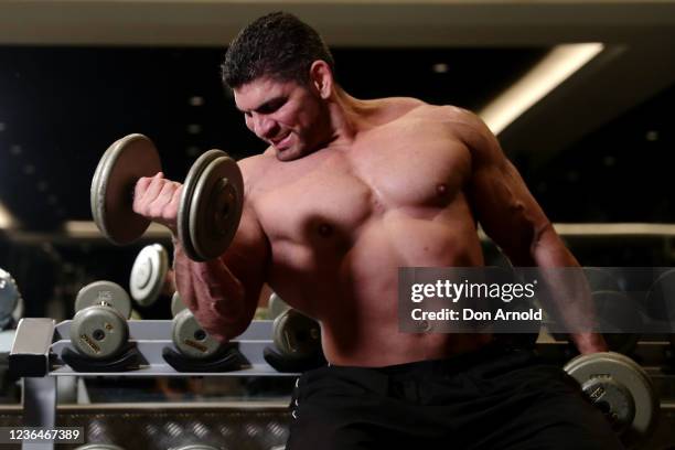 Chris Kavvalos performs some bicep curls during a workout at City Gym on May 24, 2020 in Sydney, Australia. IFBB body builder Chris Kavvalos has...