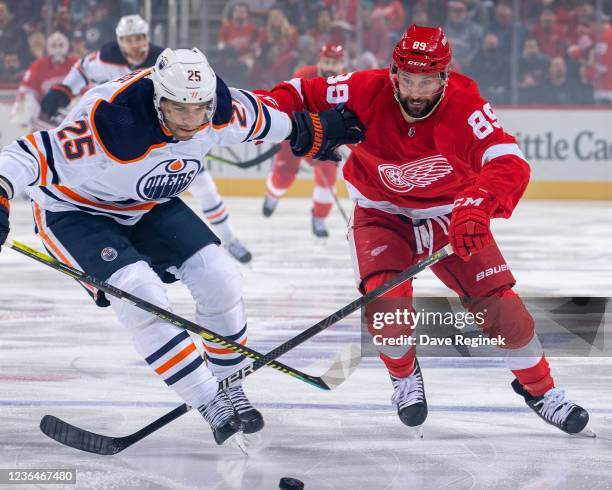 Darnell Nurse of the Edmonton Oilers and Sam Gagner of the Detroit Red Wings battle for the puck during the first period of an NHL game at Little...