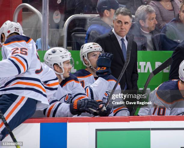 Head Coach Dave Tippett of the Edmonton Oilers looks down ice during the first period of an NHL game against the Detroit Red Wings at Little Caesars...