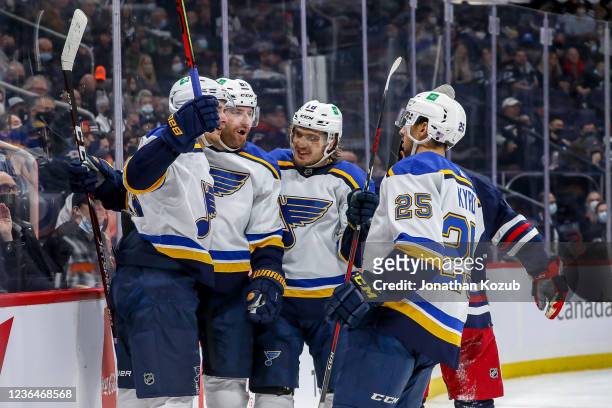 Pavel Buchnevich, James Neal, Robert Thomas and Jordan Kyrou of the St. Louis Blues celebrate a first period goal against the Winnipeg Jets at the...