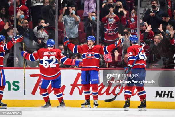 Jake Evans of the Montreal Canadiens celebrates his goal with teammates Artturi Lehkonen and David Savard during the third period against the Los...