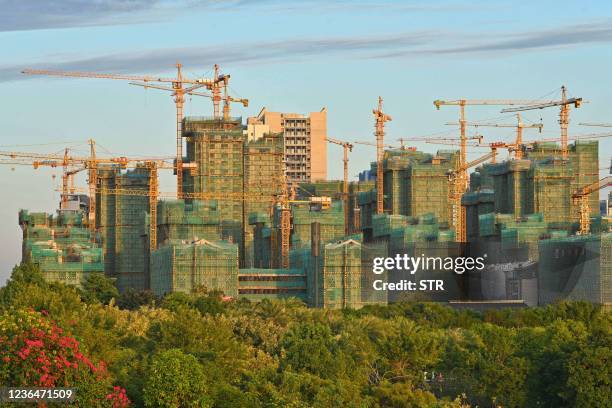 This photo taken on November 9, 2021 shows a residential and commercial complex under construction in Nanning in China's southern Guangxi region. /...