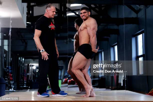 Chris Kavvalos practices posing manoeuvres under the watchful eye of PT Paul Haslam during a workout at City Gym on May 24, 2020 in Sydney,...
