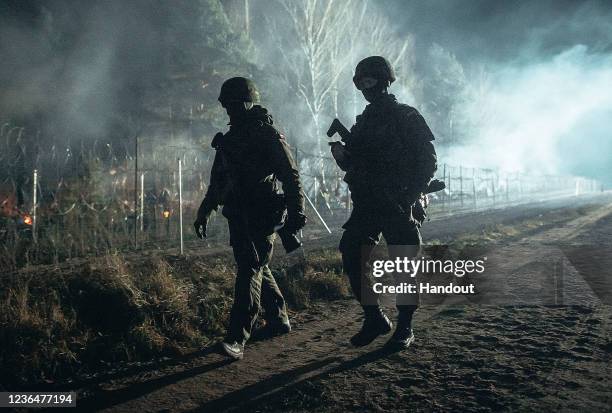 Kuznica, POLAND In this handout image issued by the Polish Ministry of National Defence, soldiers from the Polish Armed Forces patrol the...