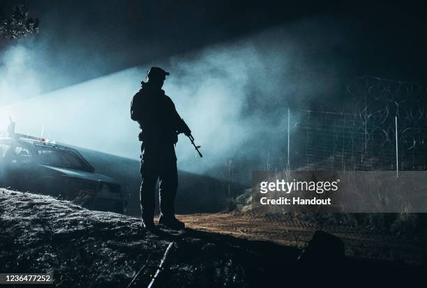 In this handout image issued by the Polish Ministry of National Defence, soldiers from the Polish Armed Forces patrol the Belarus-Polish border on...