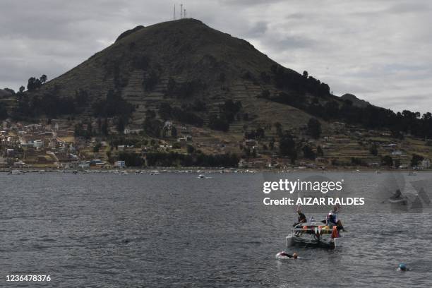 French Paralympian Theo Curin swims across Lake Titicaca in Copacabana, Bolivia on November 10, 2021. - Curin intends to cross Lake Titicaca in ten...