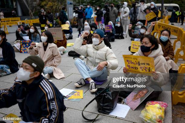 Participants shout slogans during the 1517th regular demand demonstration for solving the Japanese military sex-slavery issue hold in front of the...