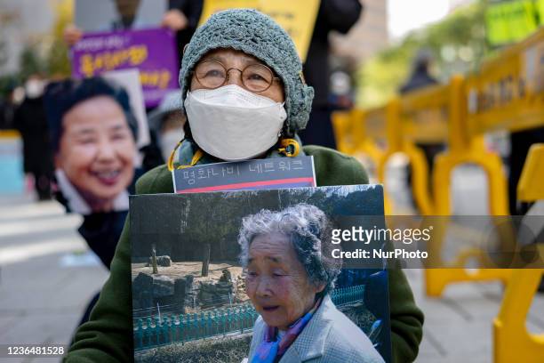Participant hold a picket during the 1517th regular demand demonstration for solving the Japanese military sex-slavery issue hold in front of the...