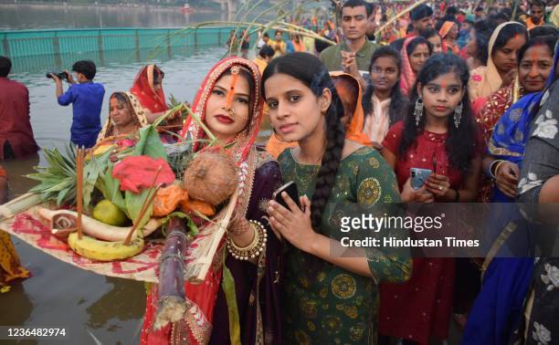 People perform rituals during the Chhath Puja festival at Laxman Mela ghat on November 10, 2021 in Lucknow, India. The festival is unique to the...
