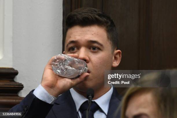 Kyle Rittenhouse takes a drink of water while testifying during his trial at the Kenosha County Courthouse on November 10, 2021 in Kenosha,...