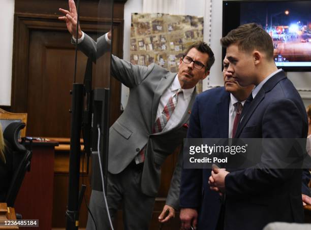 Assistant District Attorney Thomas Binger, lead defense attorney Mark Richards and Kyle Rittenhouse look at drone video evidence on a monitor during...