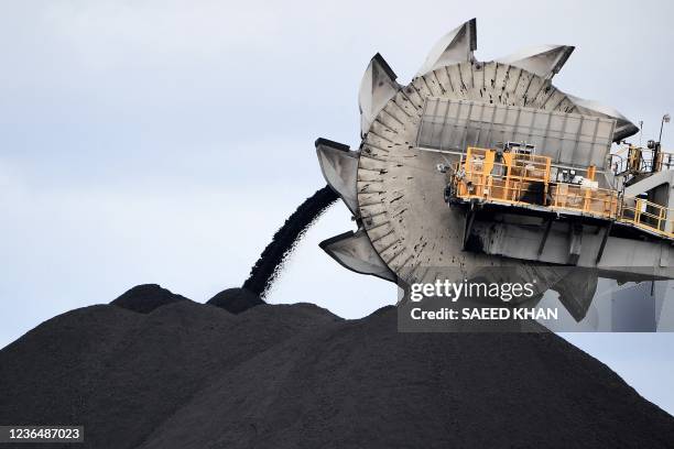 This picture taken on November 5, 2021 shows a bucket-wheel dumping soil and sand removed from another area of the mine in Newcastle, the world's...