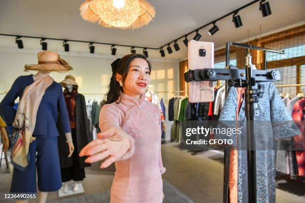 An anchor promotes clothes through an online live broadcast at a studio in Hefei, Anhui Province, China, Nov 10, 2021.