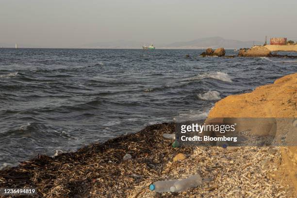 Plastic waste on a beach as a water tanker sails beyond in Aegina, Greece, on Saturday, Sept. 18, 2021. The Aegean islands are parched, breaking the...